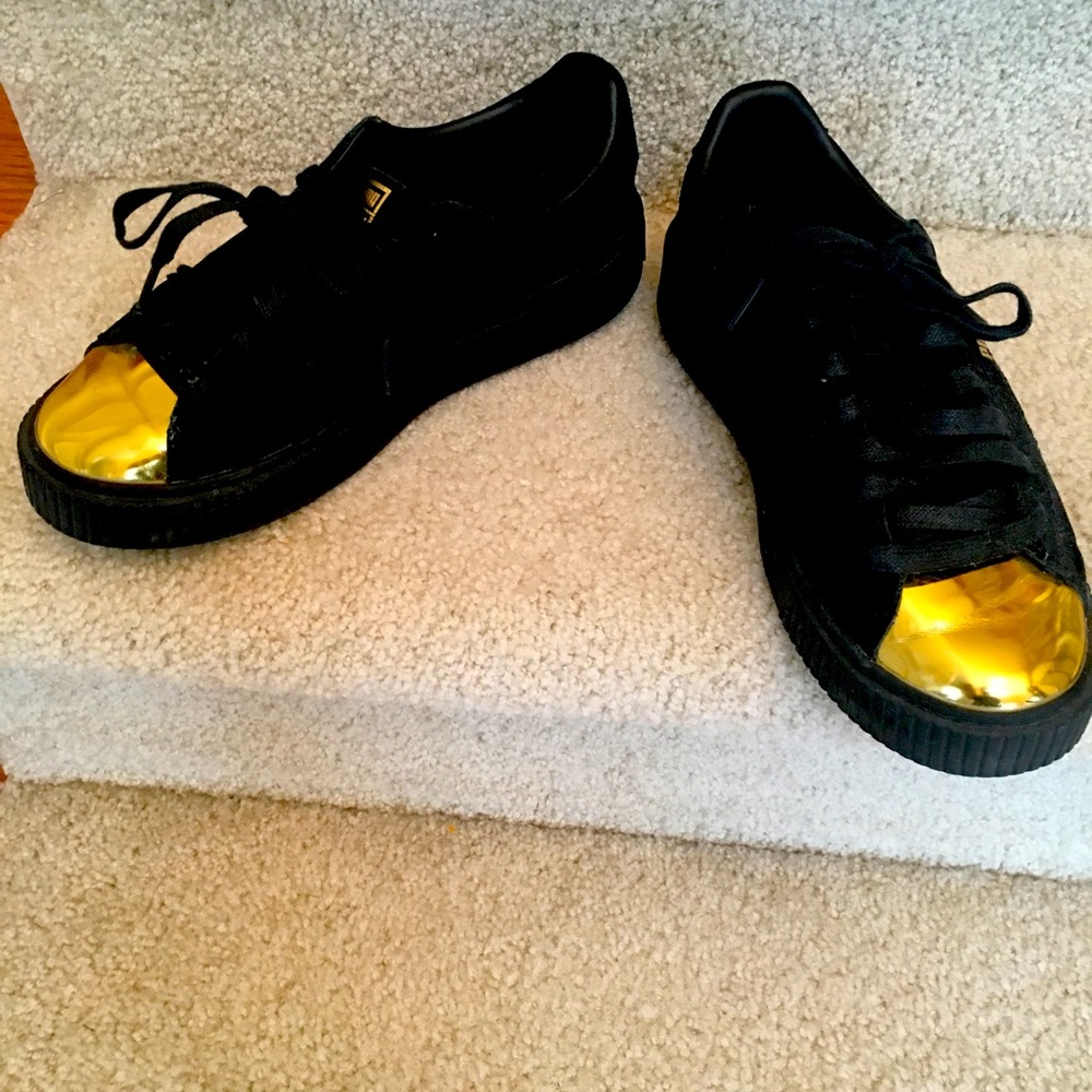 Puma black suede with gold toe.